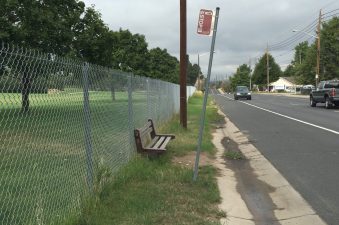 A fence separates a well-maintained public space for golfers from a poorly maintained public space for pedestrians on West 52nd Avenue. Photo: David Sachs
