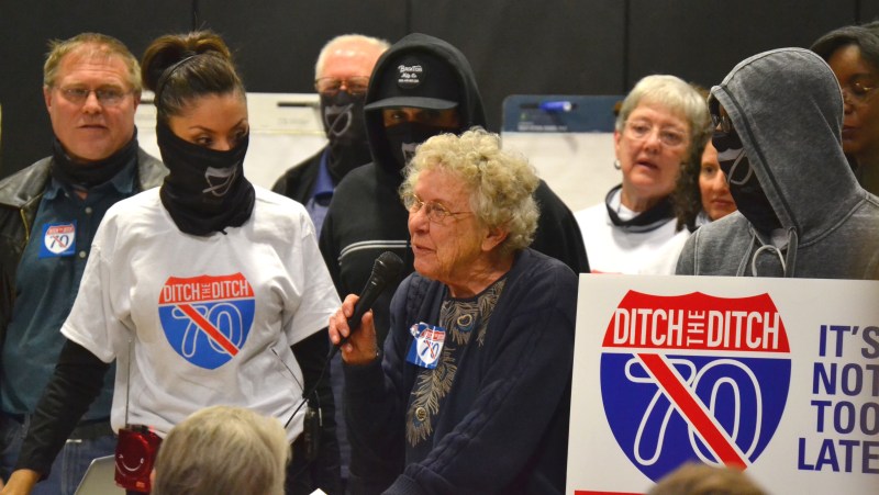 Elyria, Swansea, and Globeville residents speak out against the widening of I-70. They wore bandannas to symbolize the air pollution the project will cause. Photo: David Sachs