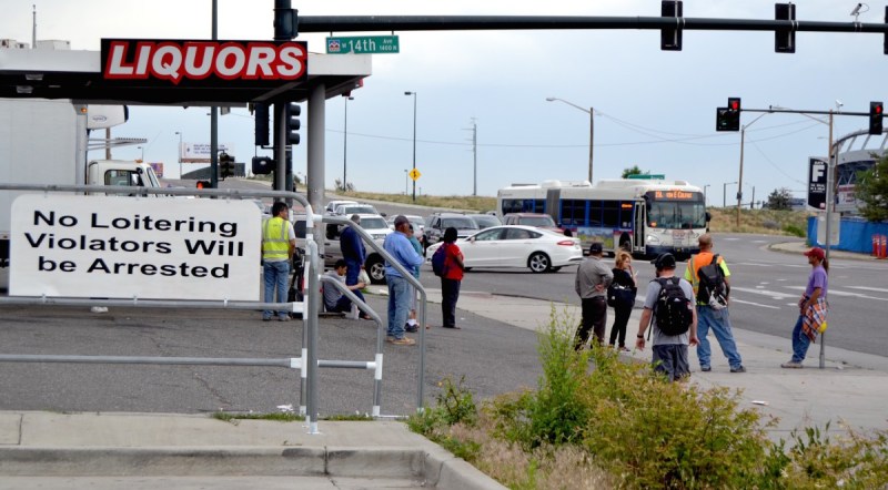 People wait at an RTD "bus stop" at the intersection of 14th Avenue, Federal Boulevard, and Howard Place. Photo: David Sachs