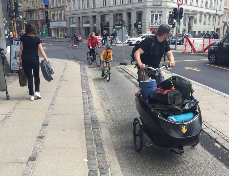 A father with a bike full of stuff, kid in tow. Photo: David Sachs