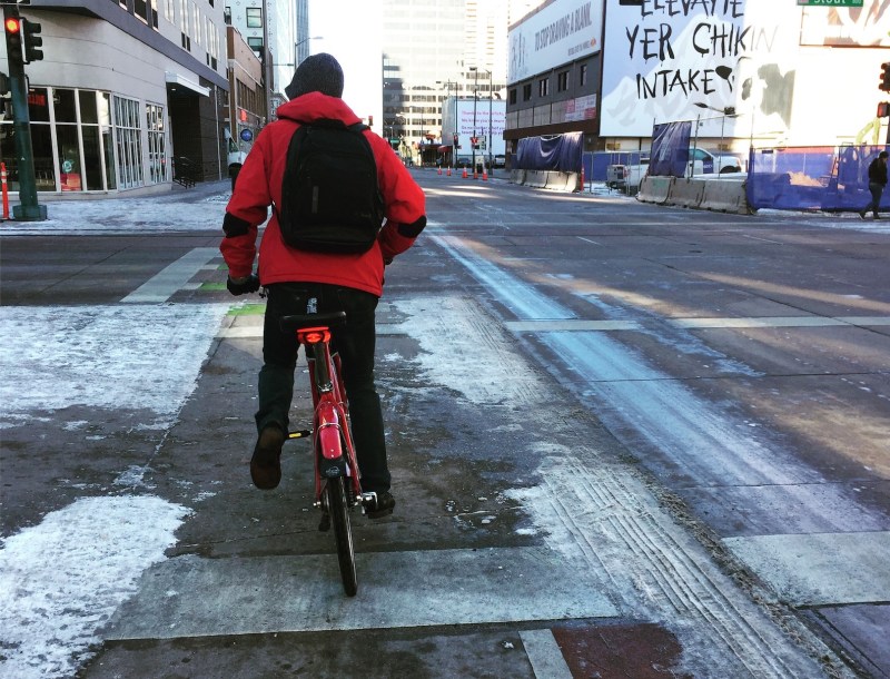 Photo person riding away on a Bcycle bike