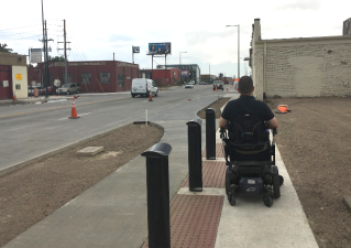 In several places along the corridor, the sidewalk is so narrow that Chris’s wheelchair barely fits. Photo: Jamie Perkins