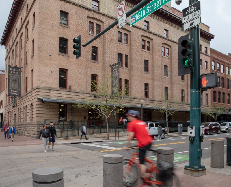 Pedestrians and a cyclist disregard a red light to cross Wynkoop St. at 16th St.