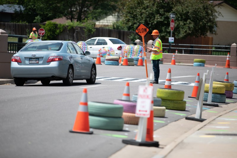 A driver slows at a temporary crosswalk at the entrance of Silverman Park Saturday. Photo: Andy Bosselman