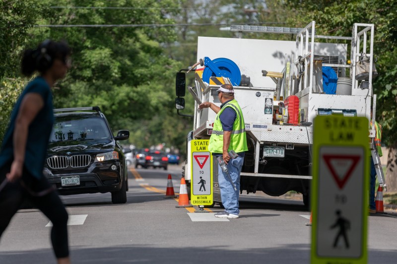 A pedestrian crosses E. Mississippi Ave. at S. Columbine St. shortly after an in-street pedestrian sign was installed Aug. 23. Photo: Andy Bosselman