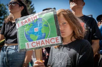 A child holds a sign on the steps of the Colorado Capitol. Photo: Andy Bosselman, Streetsblog Denver