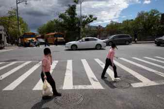 Children cross Williamsburg Street at Lee Avenue on June 21, 2019.