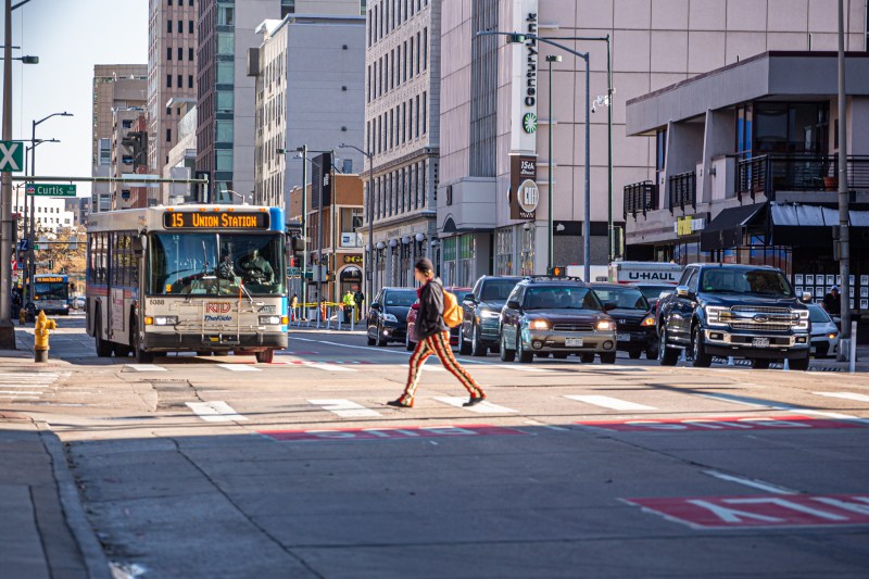 A person walks downtown. Photo credit: www.LisaMiaStudios.com