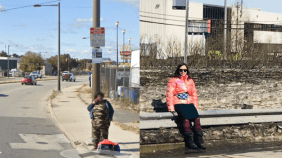 Bus stop at truck-clogged road in Philly and muddy Quebec City bus stop on the side of a French Canadian highway