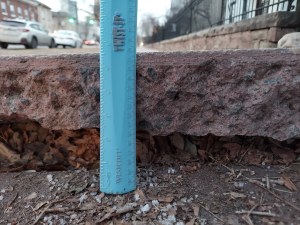 Sidewalk and ruler measuring 5.5 inch gap